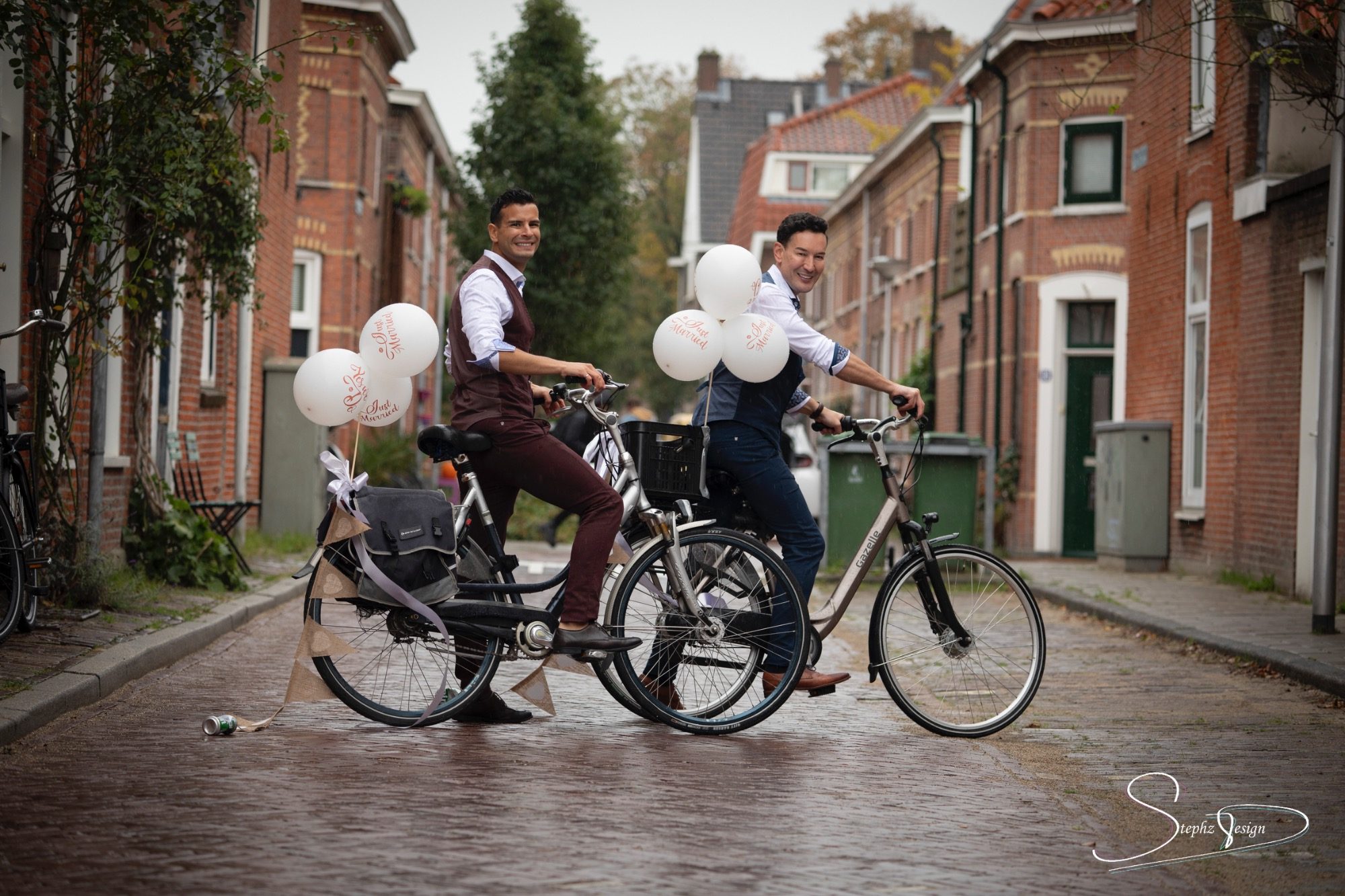 Een-mooi-bruidspaar-op-de-fiets-in-een-authentieke-straat-in-Leiden Een mooi bruidspaar op de fiets in een authentieke straat in Leiden.